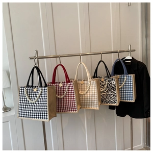 Selection of stylish woven tote bags with pearl handles and classic checkered patterns