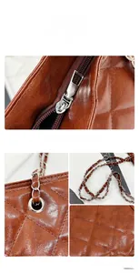 Detail of brown quilted leather bag with silver chain strap and metal zipper closure