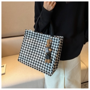 Classic houndstooth tote bag with a cute rabbit pendant accessory shown on a model