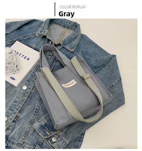 Close-up of gray canvas tote bag with Fashion label placed on denim jacket background