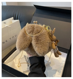 Detail of brown plush bunny bag featuring soft faux fur, long ears, and gold chain strap