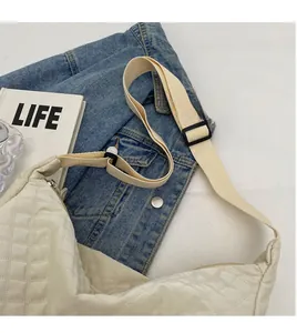 Détail de la bandoulière réglable et de la texture matelassée du sac hobo beige