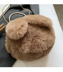 Close-up of caramel plush rabbit shoulder bag with soft faux fur and gold chain strap