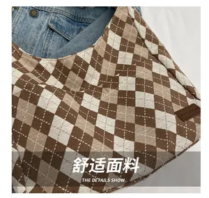 Close-up of canvas argyle pattern and brown leather label with FASHION text