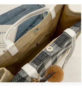 Detail of waffle tote bag featuring magnetic closure and interior zipper pocket