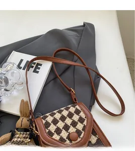 Houndstooth crossbody bag with brown leather strap and cute knitted bunny charm detail