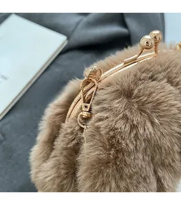 Detail of a brown faux fur bag showing the golden metal clasp and soft plush texture