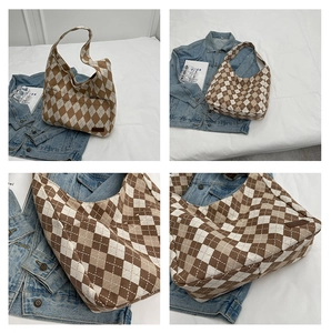 Detailed close-up of brown argyle canvas shoulder bag showing leather trim and pattern