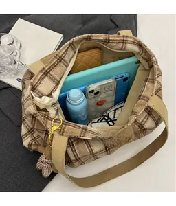 Macro view of large plaid wool tote bag interior showing spacious commute storage space