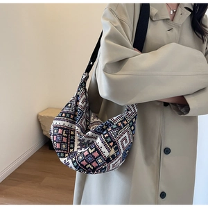 Detailed close-up of a large ethnic jacquard crossbody bag with colorful geometric patterns