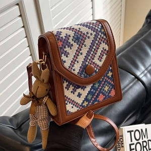 Ethnic crossbody bag in brown leather with geometric tapestry and bunny charm