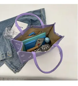 Spacious interior of purple canvas tote bag with zipper pocket and daily essentials