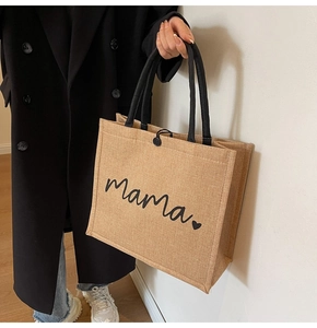 Detail of large jute tote bag featuring Mama print and thick black rope handles