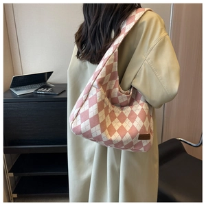 Close-up of pink and beige argyle canvas tote bag with a brown fashion label tag