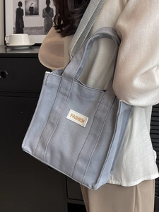 Blue canvas handbag for women with adjustable shoulder strap and FASHION label detail