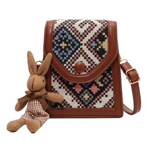 Retro ethnic style woven crossbody bag with leather trim and cute rabbit doll charm