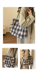 Plaid wool shoulder tote bag detail with brown bunny pendant in a lifestyle setting