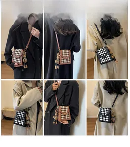 Checkerboard crossbody bags shown in various outfit styles on model with rabbit charm