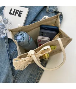 Internal view of beige canvas tote bag showing storage space for phone and umbrella