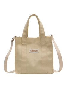 Fashionable beige canvas tote bag with crossbody strap and FASHION patch for women