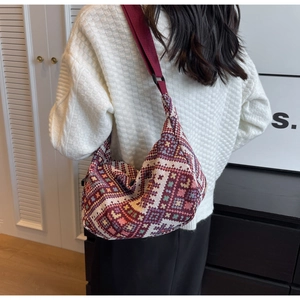 Detail view of ethnic style woven crossbody bag with colorful geometric patterns