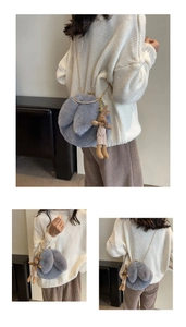 Detail of grey plush crossbody bag with bunny ears, golden chain, and rabbit charm