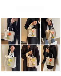 Detailed views of linen lunch tote bag with lace bow and crochet flower charms