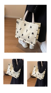Detail of a large canvas tote bag featuring minimalist black letter print design