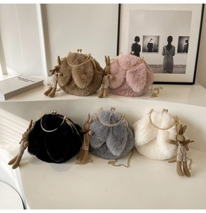 Detailed macro view of five colorful plush bunny ear bags with elegant gold chain straps