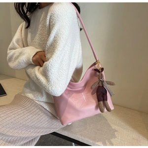 Pink lychee grain leather tote bag featuring detailed butterfly embossing and rabbit charm