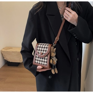 French retro houndstooth crossbody bag detail with cute bunny charm on model