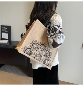 Rear view of a large linen tote bag with black mandala pattern and wide shoulder straps