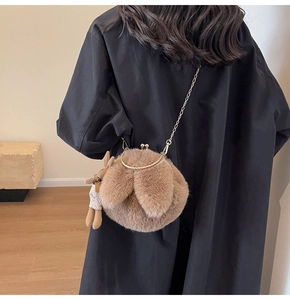 Detailed back view of a plush rabbit ear crossbody bag with gold chain and bunny charm