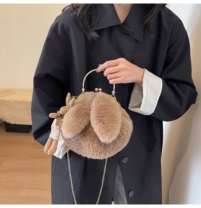 Detailed view of brown plush rabbit bag featuring soft faux fur and elegant gold metal handle