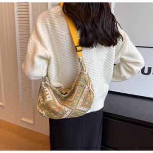 Detail of colorful geometric pattern crossbody hobo bag with yellow wide strap