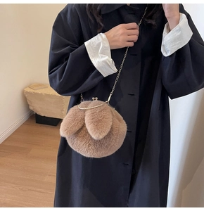 Detail of plush rabbit shoulder bag in dark khaki with metal clasp and gold chain
