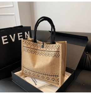 Close-up of geometric pattern on natural linen tote bag with sturdy black rope handles