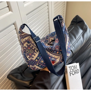 Detail of bohemian jacquard fabric texture and adjustable wide strap on crossbody bag