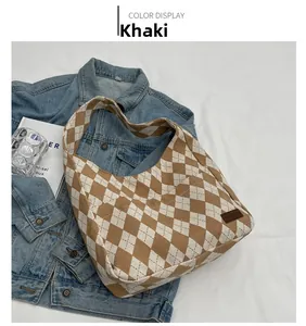 Detailed top view of a khaki checkered canvas tote bag with a brown fashion leather patch