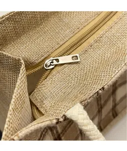 Detailed close-up of the smooth metal zipper and woven fabric texture on the lunch tote