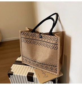 Close-up of linen tote bag with black geometric pattern and thick cotton rope handles