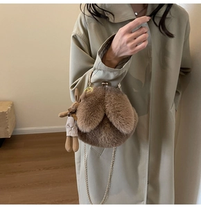 Close-up of brown plush bunny shoulder bag with vintage metal clasp and chain strap