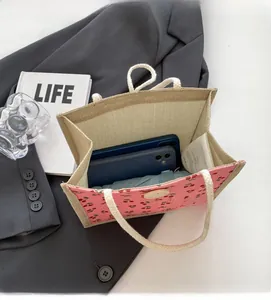 Detail of pink corduroy cherry tote bag capacity showing interior storage space