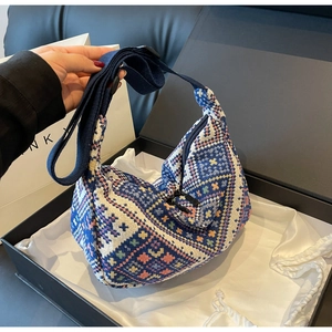 Detail view of ethnic jacquard woven bag with geometric patterns in blue gift box