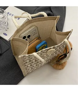 Linen woven lunch bag showing spacious interior with phone, wallet and mints