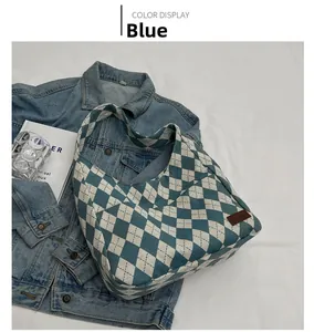 Detail view of blue and white quilted canvas hobo bag with vintage leather patch