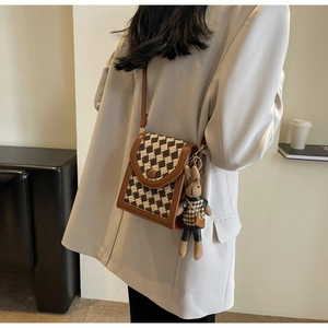 Crossbody bag with checkerboard pattern, brown leather trim and cute rabbit pendant