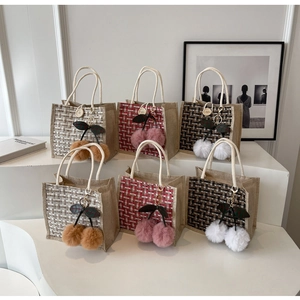 Set of woven linen tote bags in plaid patterns with decorative cherry pom-pom charms