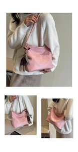 Detail of pink faux leather tote bag with butterfly embossing and a small bunny charm