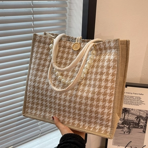 Khaki houndstooth canvas tote bag with pearl handle and wooden button closure